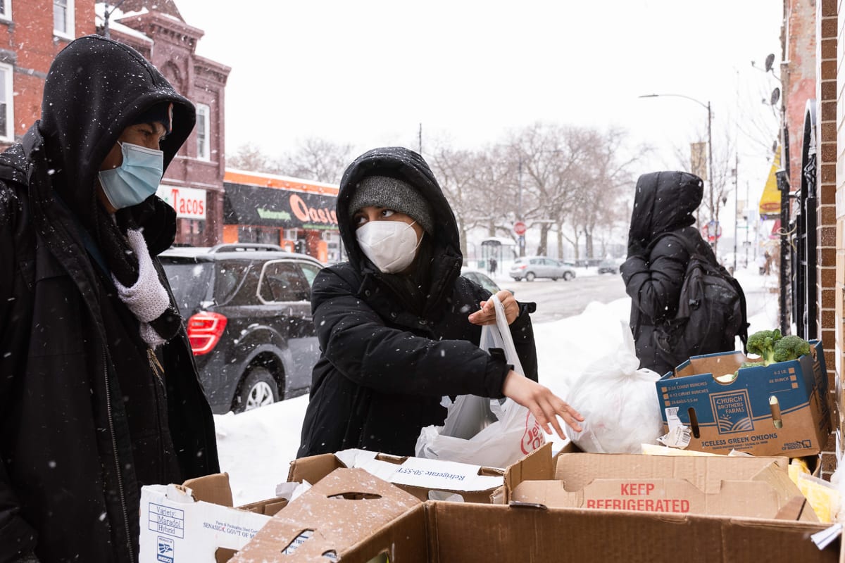 Marip Posa gives out food at the Pilsen "Free Store" in Chicago