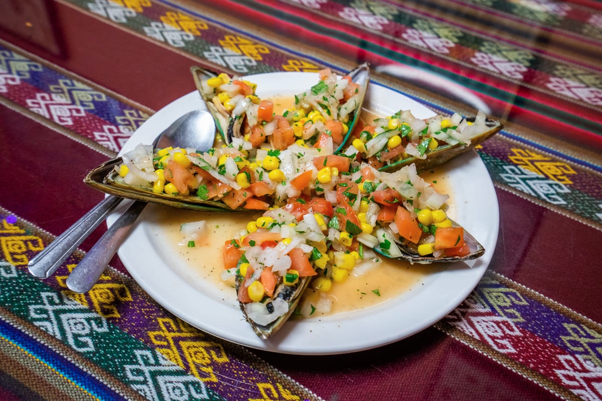 Choros a la chalaca, a traditional Peruvian dish of mussels marinated in lime then smothered in a salsa of corn, tomatoes and onions, is among the many seafood dishes offered at Rogers Park’s Taste of Peru in Chicago, Ill. Photo by Camilla Forte/Borderless Magazine