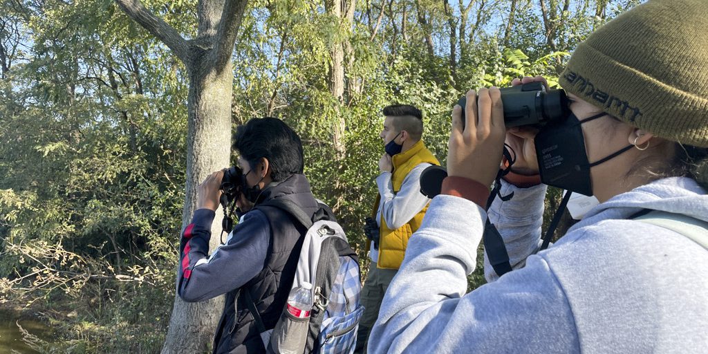 Chicago Park District students watch birds at the Big Marsh Park in Chicago as part of "small is all," a program that brings together art and the environment
