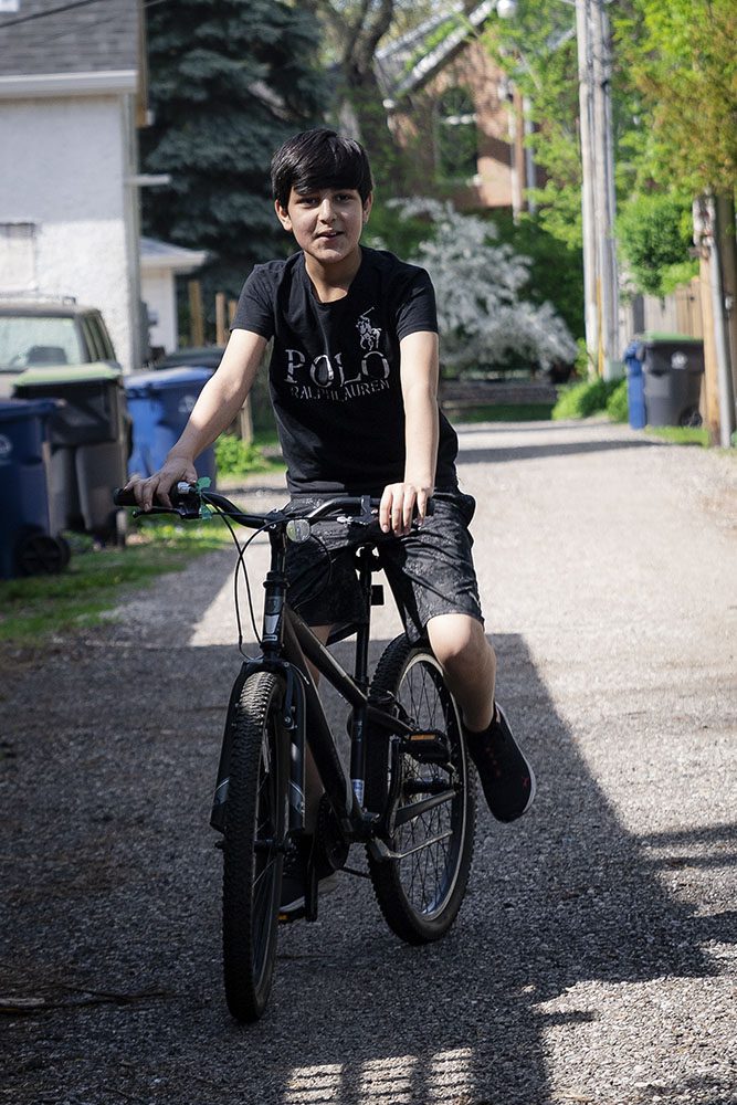 Yahya Nazari tries out a bike in an ally