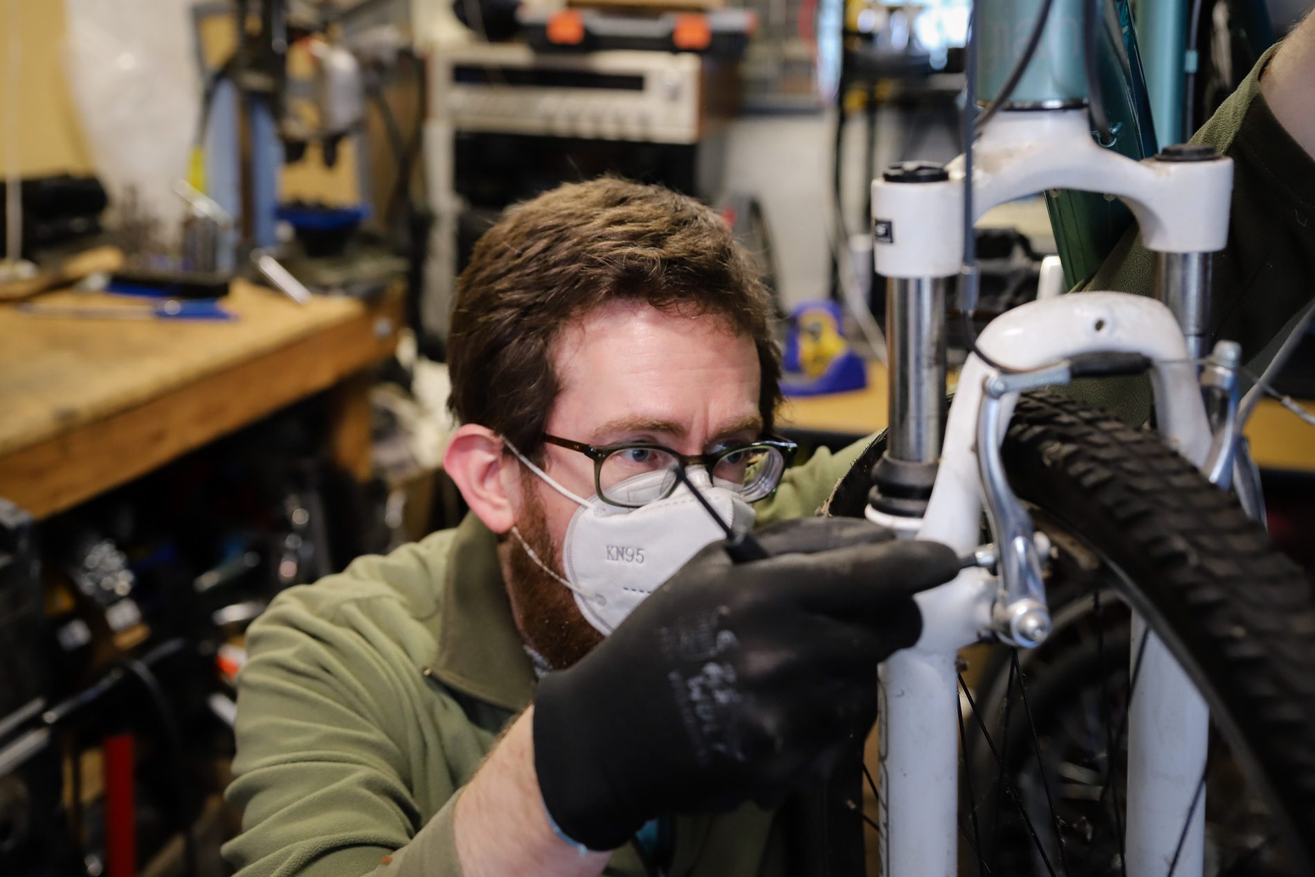 Dana Smith repairs a bicycle in his garage