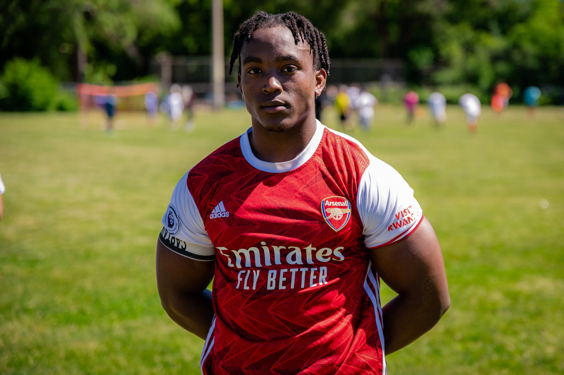 Nyibampba Wilson wearing a red jersey poses for a portrait