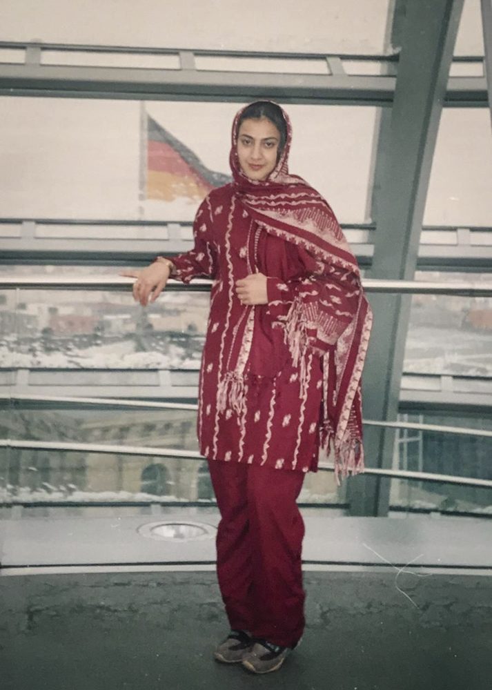 Naheed Farid with the German flag behind her