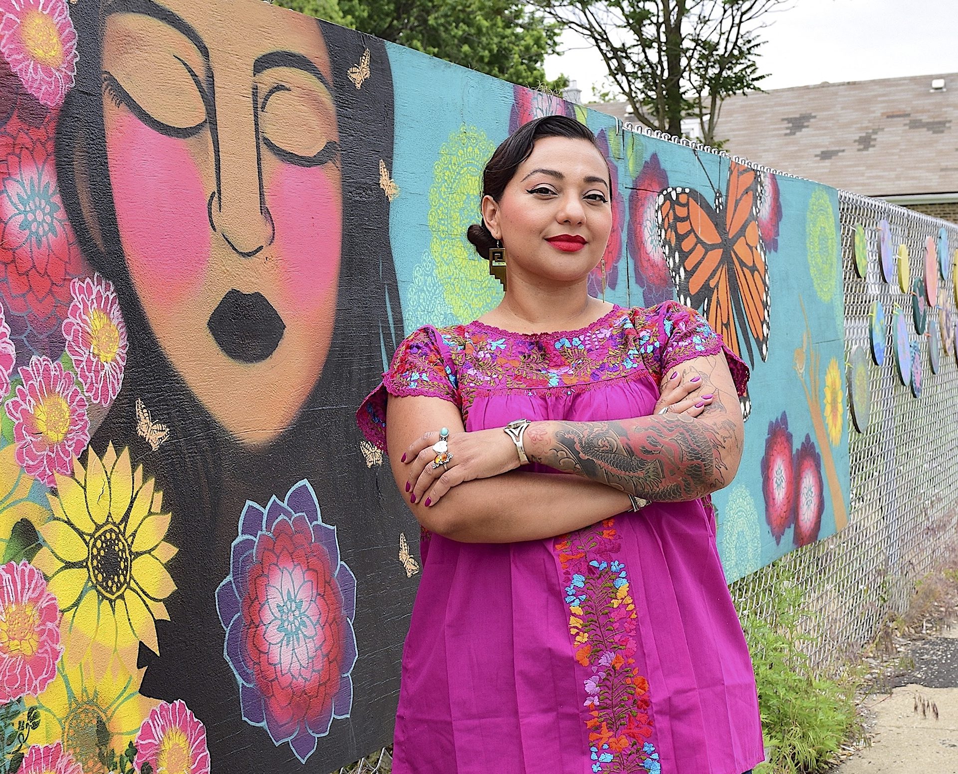 muralist Delilah Salgado with a pink dress