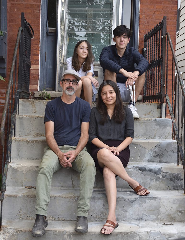 family sitting on their stoop