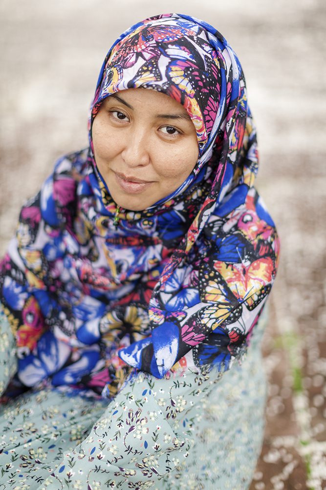 Salima Mazari outside with a blue dress and a hijab