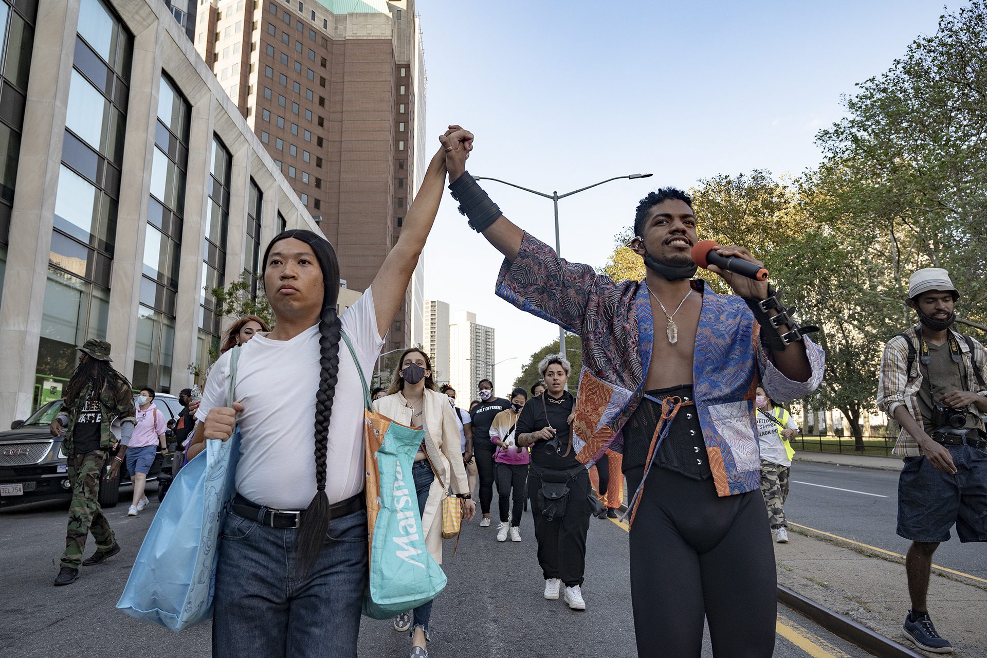 Two people holding hands in the air in solidarity