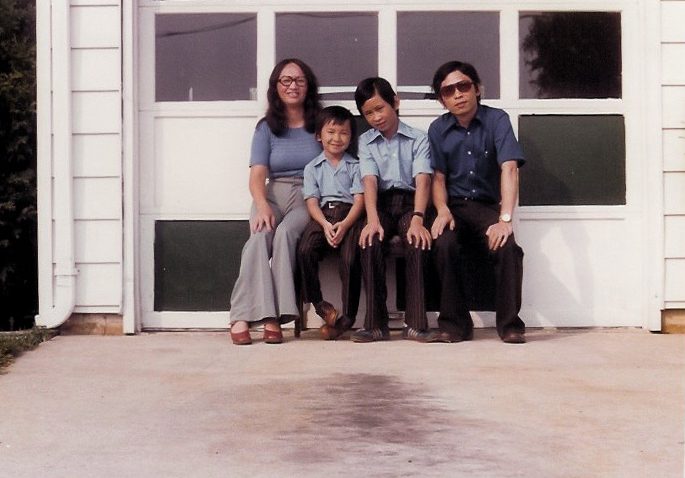 Viet Thanh Nguyen, a la izquierda en el centro, y desde la izquierda su madre, Linda Kim Nguyen, su hermano, Tung Thanh Nguyen y su padre, Joseph Thanh Nguyen delante de la puerta blanca de un garaje en 1976