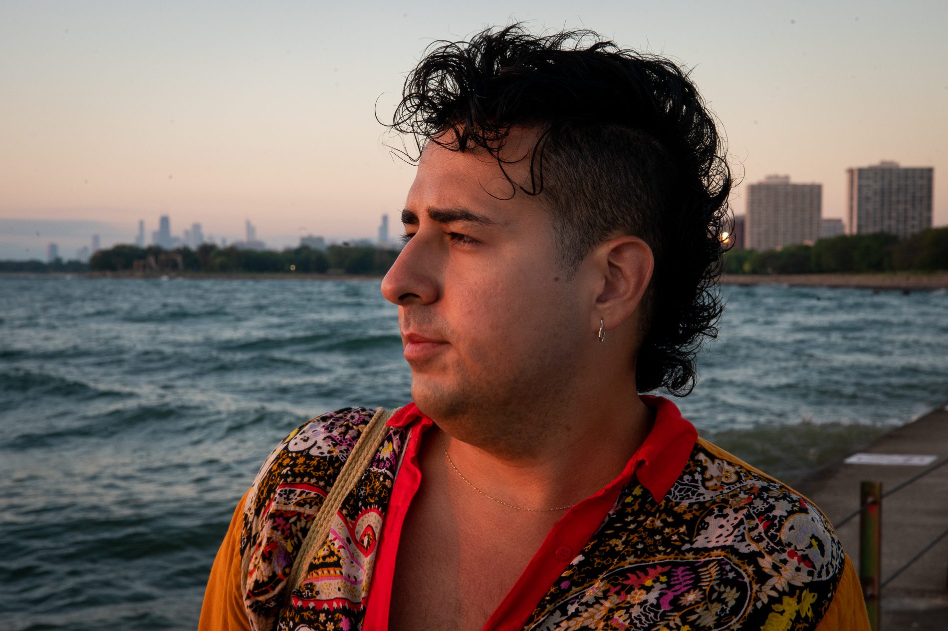 J Saxon watches the sunrise at Hollywood Beach Pier with the Chicago skyline in the background