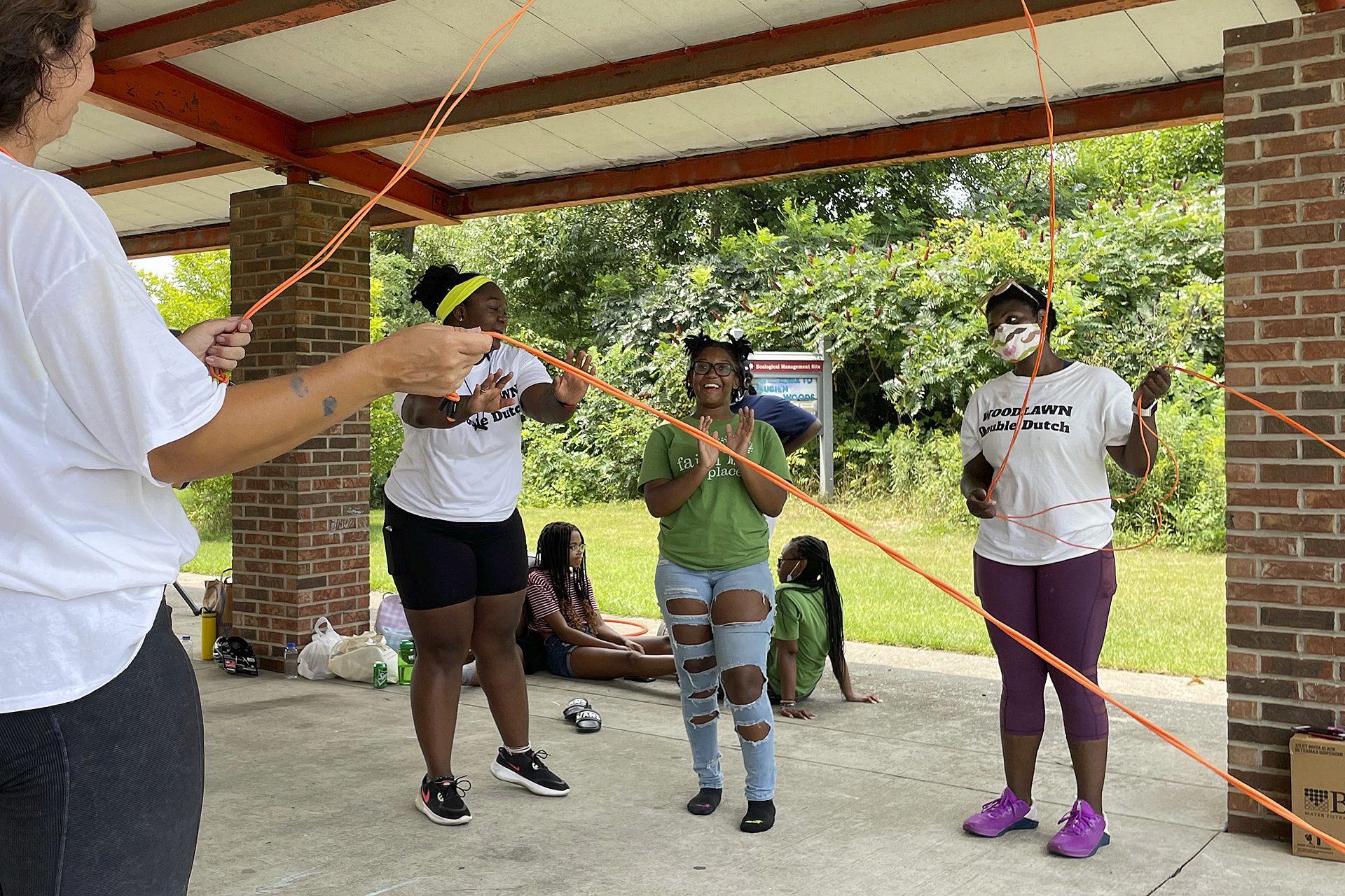 youth playing double dutch at a park