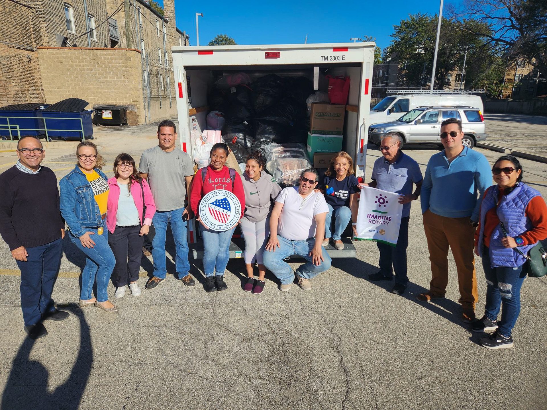 People in front of a u-haul truck that is mostly full