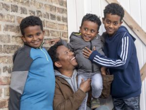 A Eritrean man poses for a photo with his three sons in the Rogers Park neighborhood in Chicago.
